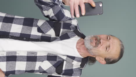 Vertical-video-of-The-old-man-making-a-video-call.